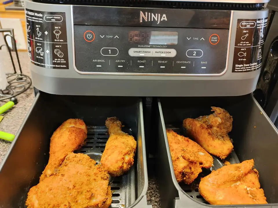 Chicken coated with flour cooking in air fryer