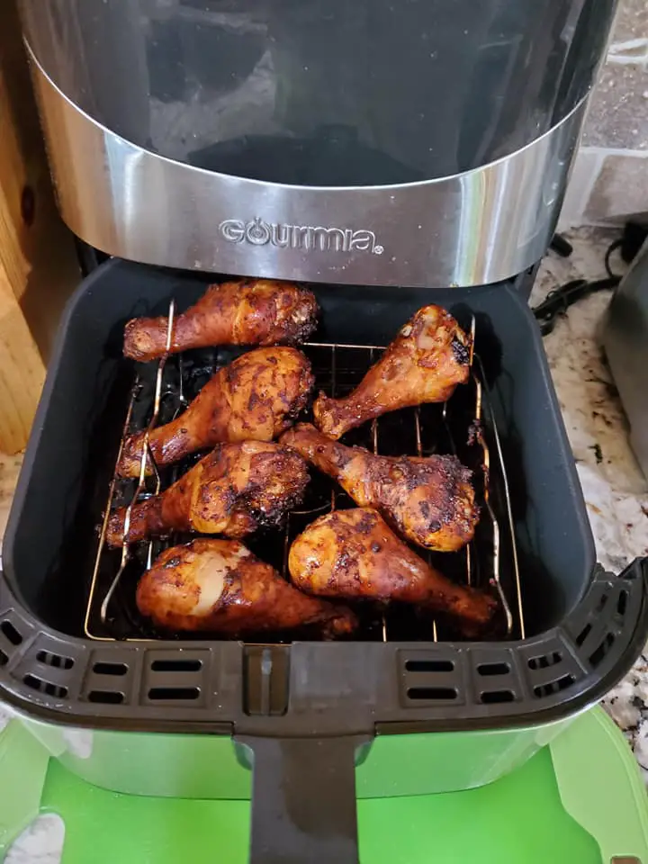 Opening the air fryer basket to stop the air fryer