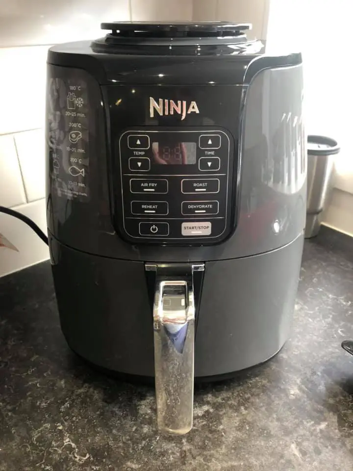 A Ninja AF101 air fryer on the countertop with adequate space to avoid overheating