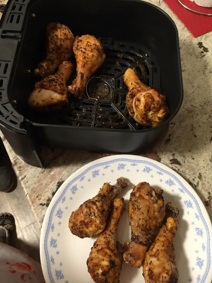 Removing chicken drumsticks from an air fryer