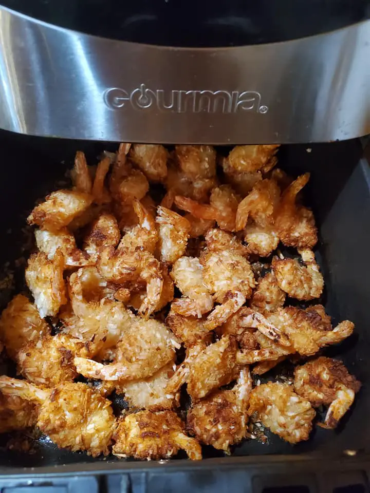 Coconut shrimp stacked in an air fryer